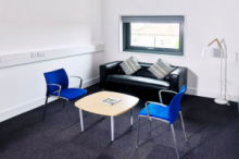 Meeting room with a sofa, table and two chairs