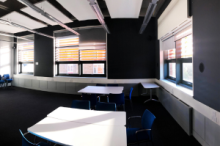 Piaget with grey walls, large windows and tables